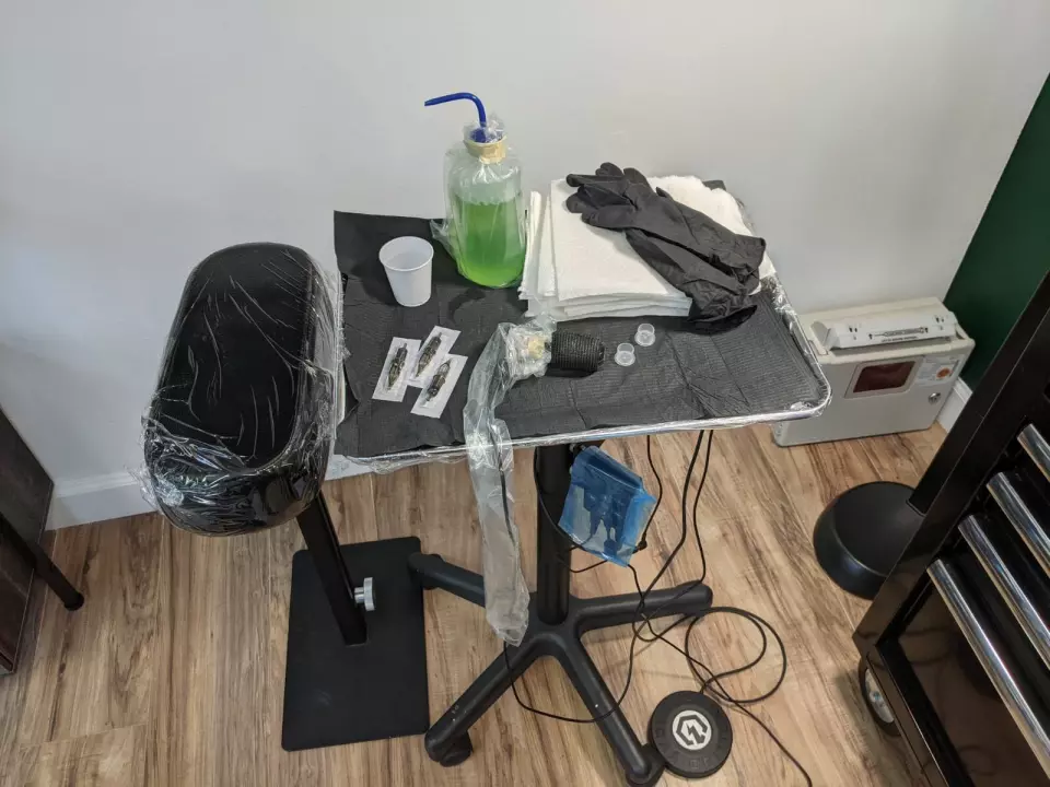 A table with a black chair and a bottle of water in Houston.