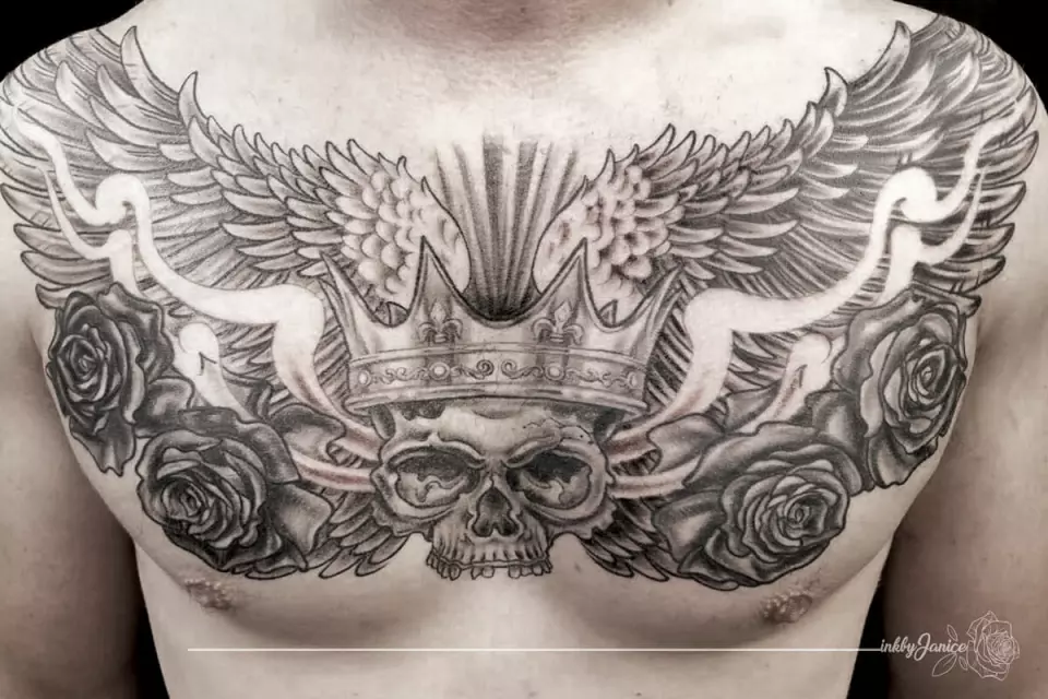 A man's chest tattoo with a crown and roses in Houston.