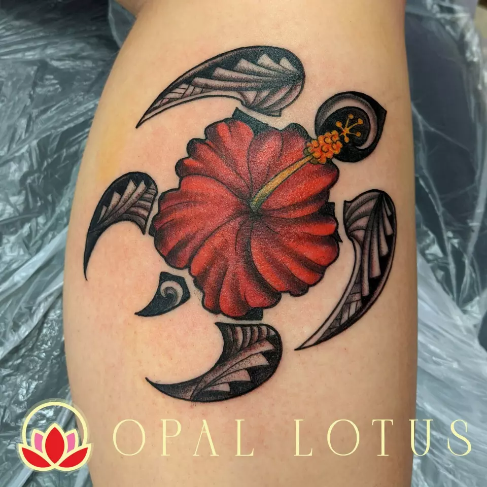 A Polynesian-inspired hibiscus tattoo on the thigh.