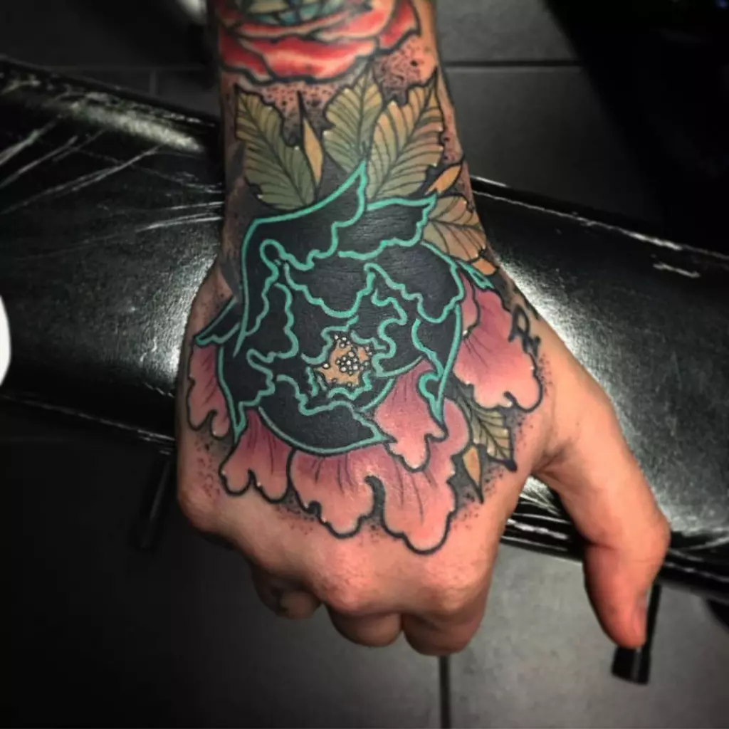 A traditional Japanese flower tattoo adorning a hand in Katy.