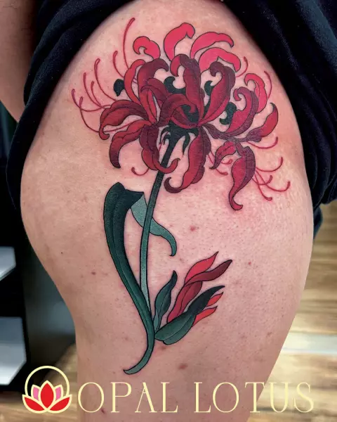 A traditional Japanese tattoo of a red flower on the thigh in Katy.