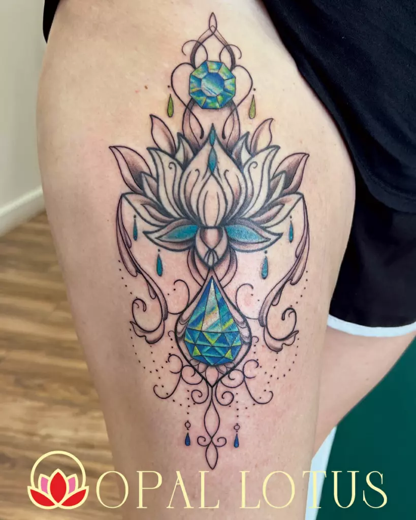 A tattoo of a lotus flower on Janice's thigh, done in black and grey.