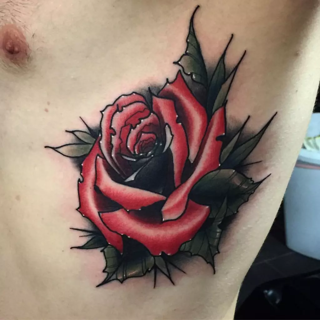 A new school tattoo of a red rose on a man's chest.