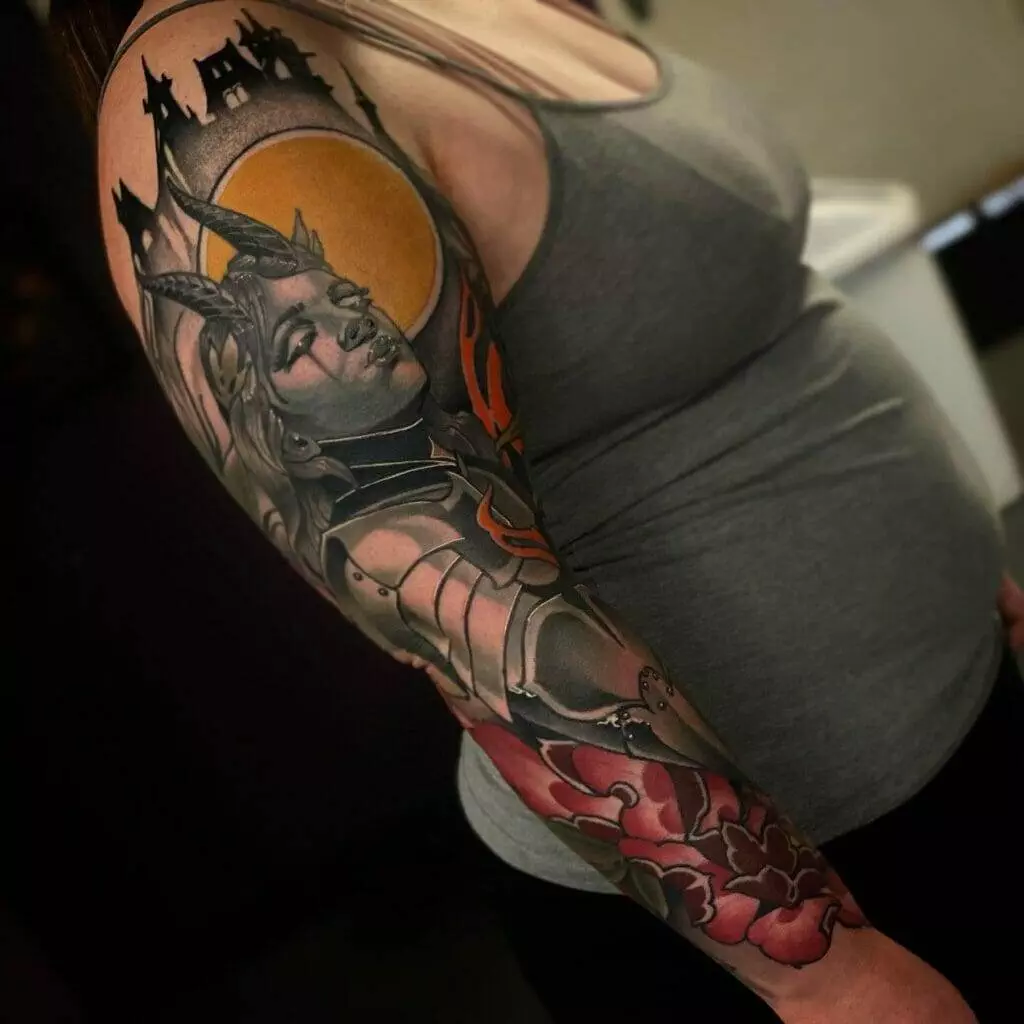 A woman with a tattoo sleeve featuring a sword-wielding woman in Katy, Houston.