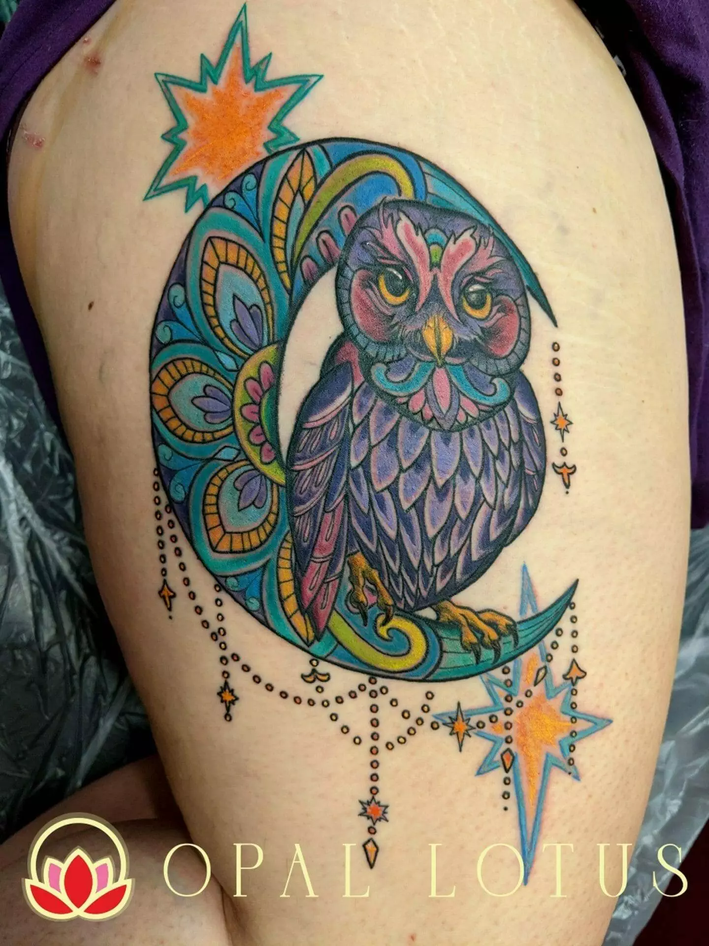A neo-traditional tattoo featuring a katy-inspired owl perched on a crescent.