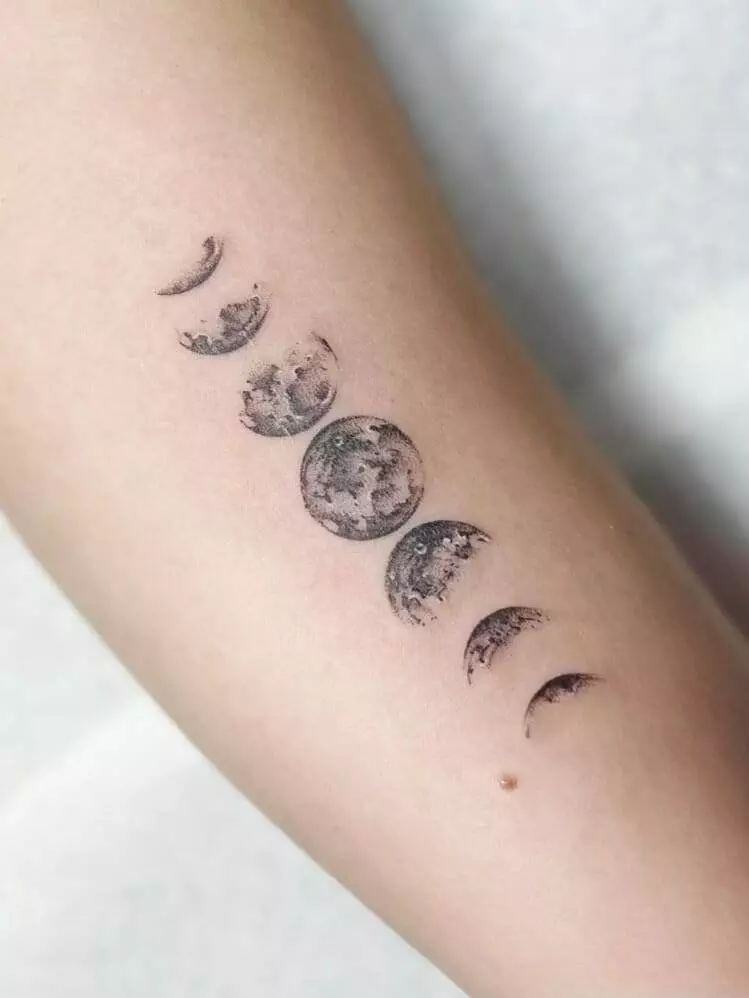 moon tattoo, woman, forearm.