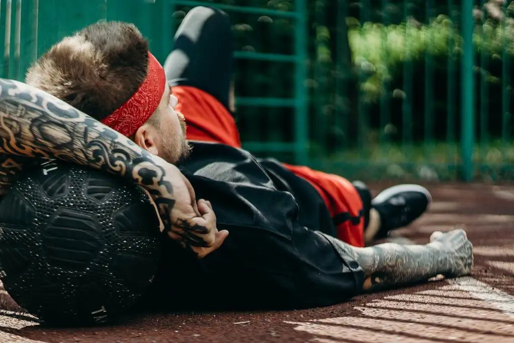 A Man Lying Down on a Basketball